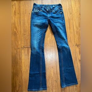Miss me jeans with stars and diamond embellishments on back pockets.